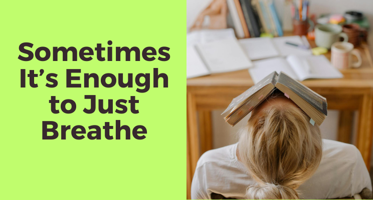 woman exhausted at her messy desk leaning back in her chair with a book over her face feeling resigned